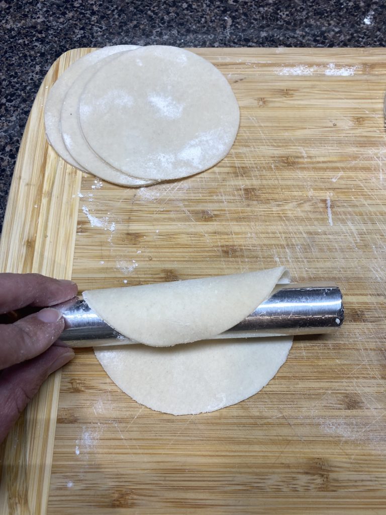 Wrapping the crust around the form.