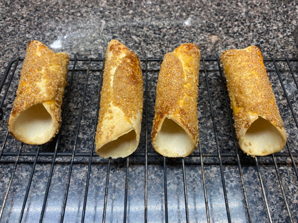 Air fryer cannoli shells cooling on wire rack